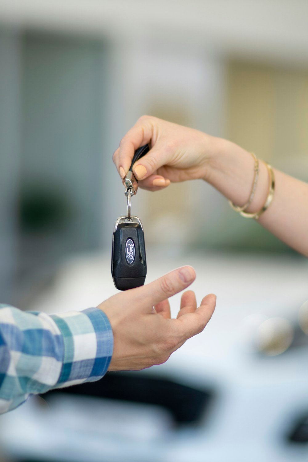 Car keys being handed to a customer